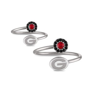May include: Two silver rings with a red and black stone and a white 'G' on the band.