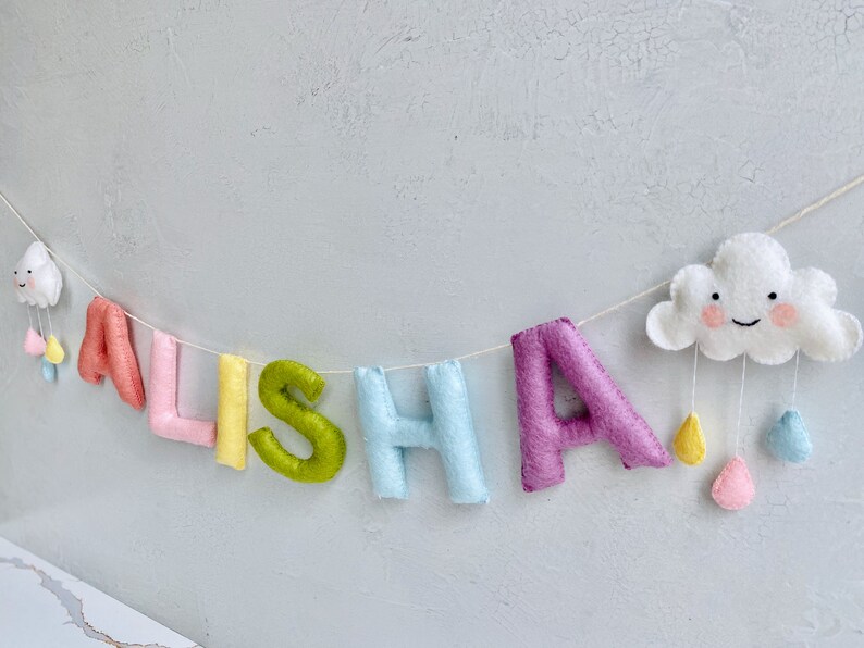 name banner in pastel rainbow shades with cute clouds.