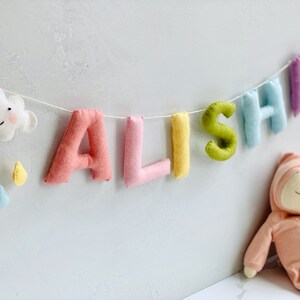 pastel name bunting to add a pop of color to rainbow themed nursery