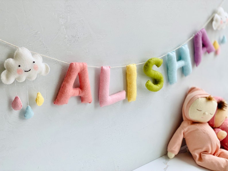 pastel name bunting to add a pop of color to rainbow themed nursery