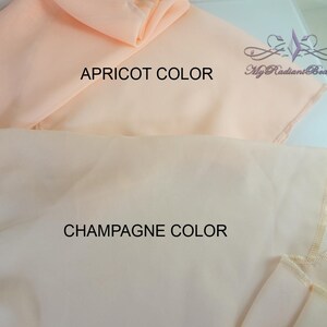 May include: Two pieces of fabric, one apricot color and one champagne color. The fabric is sheer and has a delicate, scalloped edge.