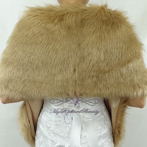 May include: A brown faux fur shawl with a satin lining. The shawl is draped over a white dress with lace detailing.