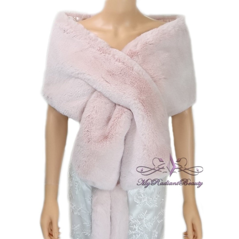 May include: A soft pink faux fur shawl, draped over a mannequin's shoulders. The shawl is made of a fluffy, plush fabric and has a simple, elegant design.  My Radiant Beauty is printed on the bottom right corner of the image.