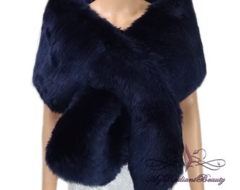 May include: A navy blue faux fur shawl. The shawl is draped over a mannequin's shoulders and is styled to show the length and width of the shawl.