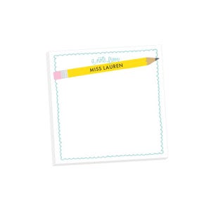 May include: A white notepad with a light blue scalloped border and a yellow pencil design. The pencil has a pink eraser and the text "a note from MISS LAUREN" is printed on the notepad.