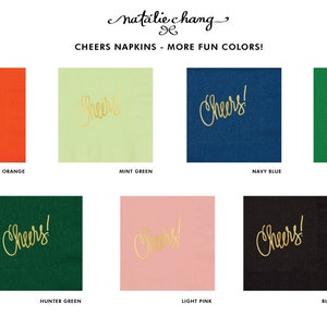 May include: A set of eight napkins with the word "Cheers!" printed in gold lettering on different colored backgrounds. The colors include coral orange, mint green, navy blue, kelly green, hunter green, light pink, and black.