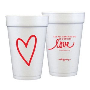 May include: Two white foam cups with red designs. One cup has a red heart and the other has the text "Let all that you do be done in love 1 Corinthians 16-14 Natalie Chang".