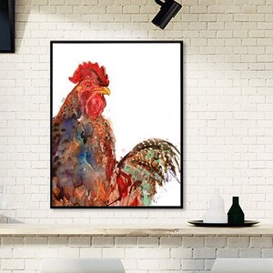 May include: A framed watercolor painting of a rooster. The rooster has a red comb and wattle, with a body of blue, brown, and orange hues. The artwork is displayed on a white brick wall above a wooden bar with stools.