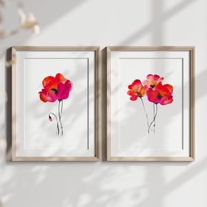 May include: Two framed watercolour paintings of red poppies. The painting on the left features a single poppy with a bud, while the painting on the right features three poppies.