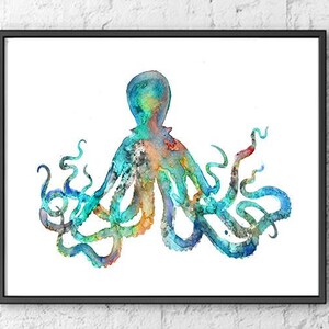 May include: Watercolor painting of an octopus in a black frame. The octopus is depicted in shades of blue, teal, orange, and red. The tentacles curl and twist against a white background. The artwork is framed and ready to hang.