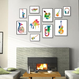 K&ouml;nnte beinhalten: Ein Set aus neun bunten Aquarellbildern von Musikinstrumenten, darunter ein Saxophon, eine Trompete, ein Klavier, ein Schlagzeug, eine Gitarre, ein Cello, ein Waldhorn, eine E-Gitarre und Kopfh&ouml;rer. Die Bilder sind gerahmt und an einer wei&szlig;en Wand &uuml;ber einem Kamin angebracht.
