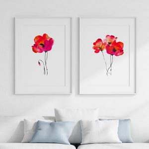 May include: Two framed watercolour paintings of red poppies. The painting on the left features a single poppy with a bud. The painting on the right features three poppies.