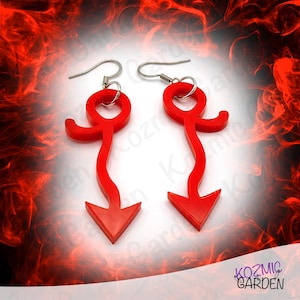 May include: A pair of red acrylic earrings with an arrow design. Each earring has a curved top, a slender body, and a pointed arrow at the bottom. The earrings have silver-coloured ear wires.
