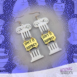 May include: A pair of white and gold-colored earrings. The earrings feature a column design with the text "Isn't it Ionic?" on a gold-colored plaque. The earrings have a hook closure.