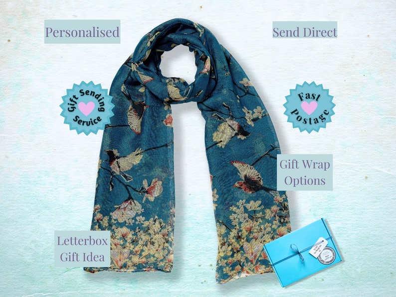 May include: A teal blue scarf with a floral and bird print. The scarf is folded and displayed on a white background. The text "Send Direct", "Fast Postage", "Gift Wrap Options", "Letterbox Gift Idea", "Personalised", and "Gift Sending Service" is visible in the image.