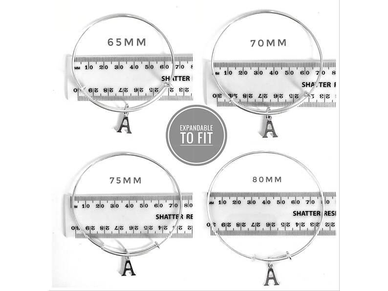 May include: Four silver expandable bangle bracelets with a letter 'A' charm. The bracelets are measured in millimeters: 65mm, 70mm, 75mm, and 80mm.