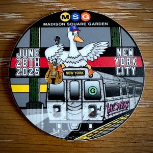 May include: Circular sticker featuring a cartoon goose wearing a baseball cap and holding a guitar, with the text "MSG Madison Square Garden" and "New York City." The design includes a subway train and the date "June 28th 2025."