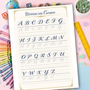 May include: A cursive handwriting practice sheet featuring the uppercase alphabet in a blue script. The sheet includes dotted lines for tracing and solid lines for practice. The title "Uppercase Cursive" is at the top. The background includes crayons, a globe, and a succulent plant.