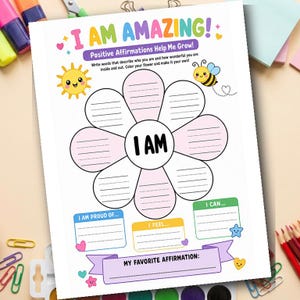 Puede incluir: Un papel blanco con el texto "I AM AMAZING!" y "Positive Affirmations Help Me Grow!" en texto colorido. El papel presenta un gráfico en forma de flor con indicaciones de escritura e ilustraciones de un sol y una abeja.