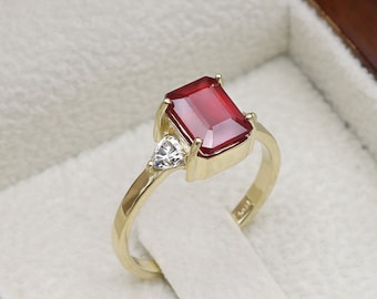 Ruby Gold ring with a pair of trillion cut moissanites