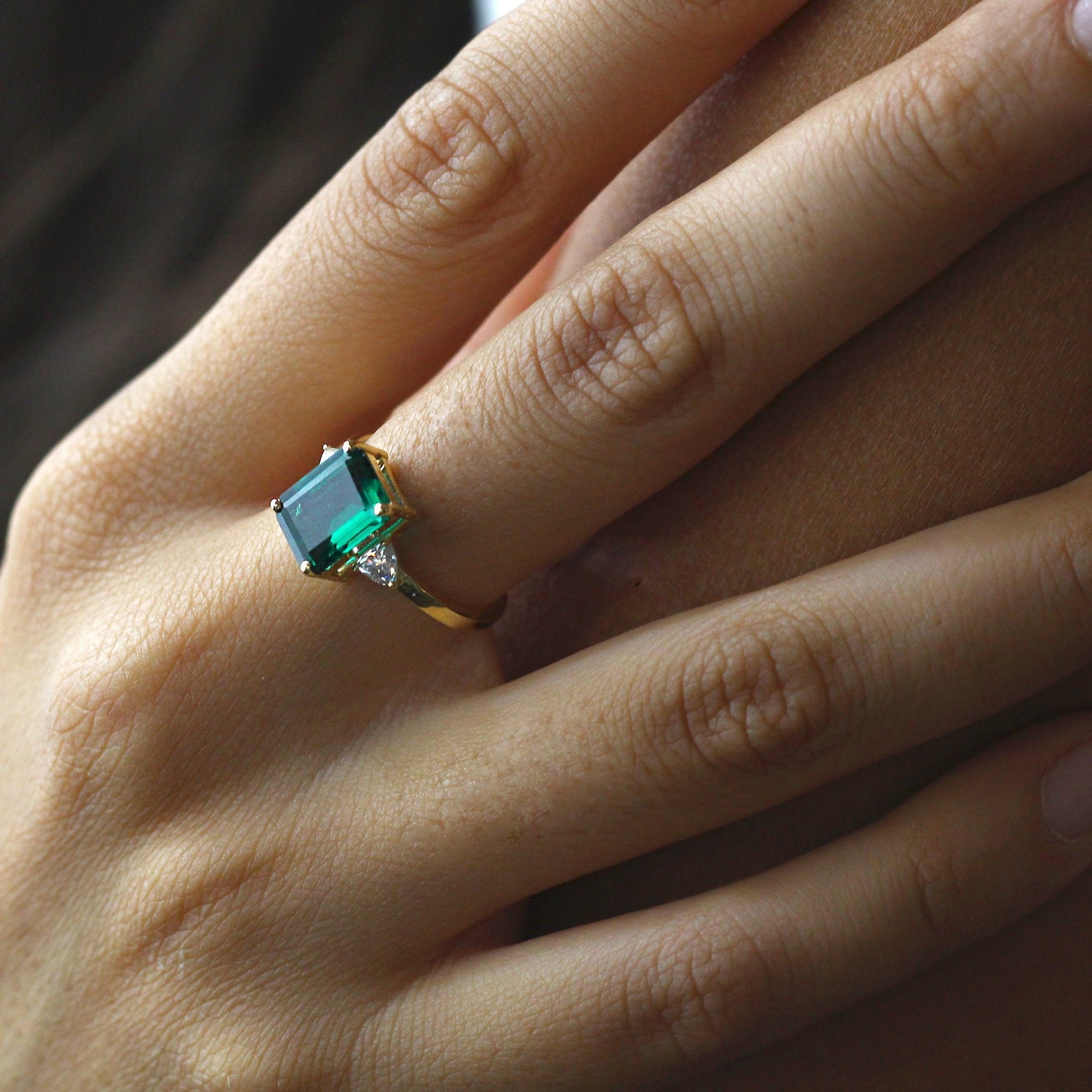 Emerald Gold ring with a pair of trillion cut moissanites