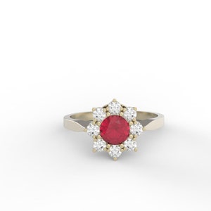 May include: A gold ring with a red ruby gemstone surrounded by smaller white diamonds in a flower shape.