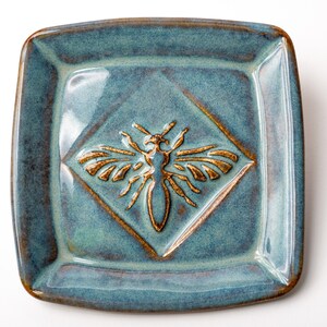 Artisan crafted Honey Bee soap dish 4" x 4" from stoneware with raised edges and rustic blue glaze fired at 2,232 degrees in my home kiln.