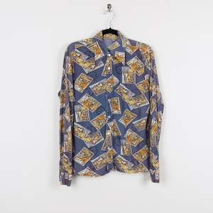 May include: A long-sleeved button-up shirt with a blue background and a pattern of yellow and brown postage stamps.