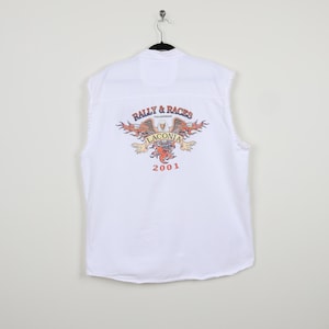 May include: White sleeveless shirt with a graphic print of a winged eagle with flames and the text "Rally & Races" and "Laconia 2001".