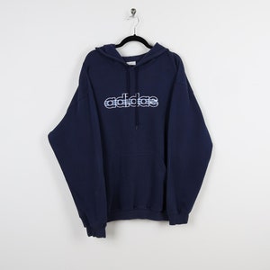 May include: A navy blue hooded sweatshirt with a white "adidas" logo on the front. The logo is in a stylized font with white lines.