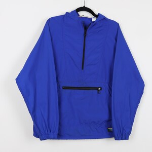 May include: A blue hooded pullover jacket with a half-zip closure and a zippered pocket on the front. The jacket has a small patch with the brand name "L.L.Bean" on the bottom right side.