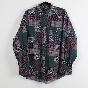 May include: A long-sleeve button-down shirt featuring a multi-colored patchwork design. The pattern consists of various squares in shades of dark green, navy blue, and burgundy, decorated with paisley, geometric, and small dot motifs throughout.