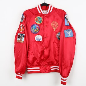 May include: A set of three ceramic mugs with a speckled, matte finish. The mugs are in shades of cream, light gray, and dark gray. Each mug has a simple, minimalist design and a rounded handle.