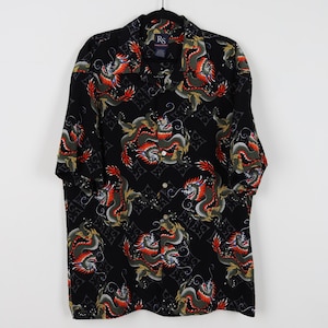 May include: Black button-down shirt with a dragon pattern in red, green, and gold. The shirt has short sleeves and a classic collar. The dragon design is repeated across the fabric.