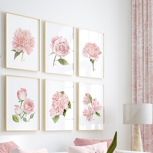 May include: A set of six framed watercolour prints featuring pink flowers. The prints are arranged in a grid pattern on a white wall. The flowers include roses, peonies, and hydrangeas.