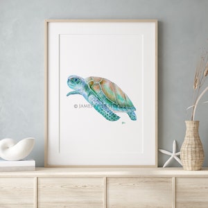 May include: A watercolor painting of a sea turtle swimming in the ocean. The turtle is painted in shades of blue, green, and brown. The painting is framed in a simple wooden frame.