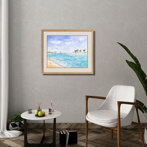 May include: A watercolor painting of a beach scene with palm trees, blue water, and a sailboat in the distance. The painting is framed in a light wood frame.