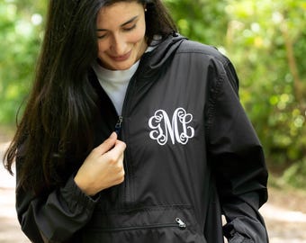May include: A black hooded pullover jacket featuring a white embroidered monogram with the letters GML on the left chest. The jacket has a front zipper closure, a kangaroo pocket, and elasticized cuffs on the long sleeves.