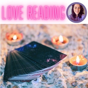 May include: A deck of tarot cards with a galaxy design, spread out on a fabric surface with three lit candles. The text "LOVE READING" is in pink neon letters at the top of the image.