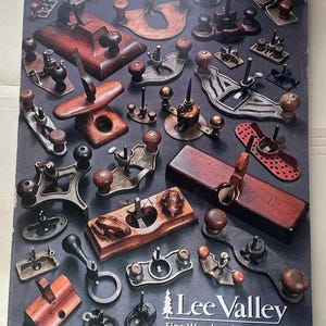 May include: A collection of various woodworking tools, including planes, spokeshaves, and other specialized instruments. The tools are made of wood and metal, with a variety of shapes and sizes. The image includes the text "Lee Valley Fine Woodworking Tools 2016-2017".