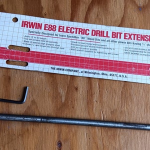 May include: A silver drill bit extension with a black hex wrench. The packaging is red and white with the text "IRWIN E88 ELECTRIC DRILL BIT EXTENSION" and "Specially Designed for Irwin Speeder " and Bits and all other power bits having 1/4" chucks".