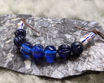 String of 13 artisanal glass Viking beads