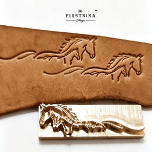 May include: A rectangular brass metal stamp featuring a raised design of two horses running, positioned below a piece of tan leather embossed with the same horse pattern. The text "The FIRSTNINA Design" is printed in black above the leather piece.