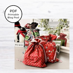 Może przedstawiać: Trzy czerwono-białe materiałowe torby prezentowe z różnymi wzorami. Torby są związane czerwoną wstążką i gotowe do wręczenia.