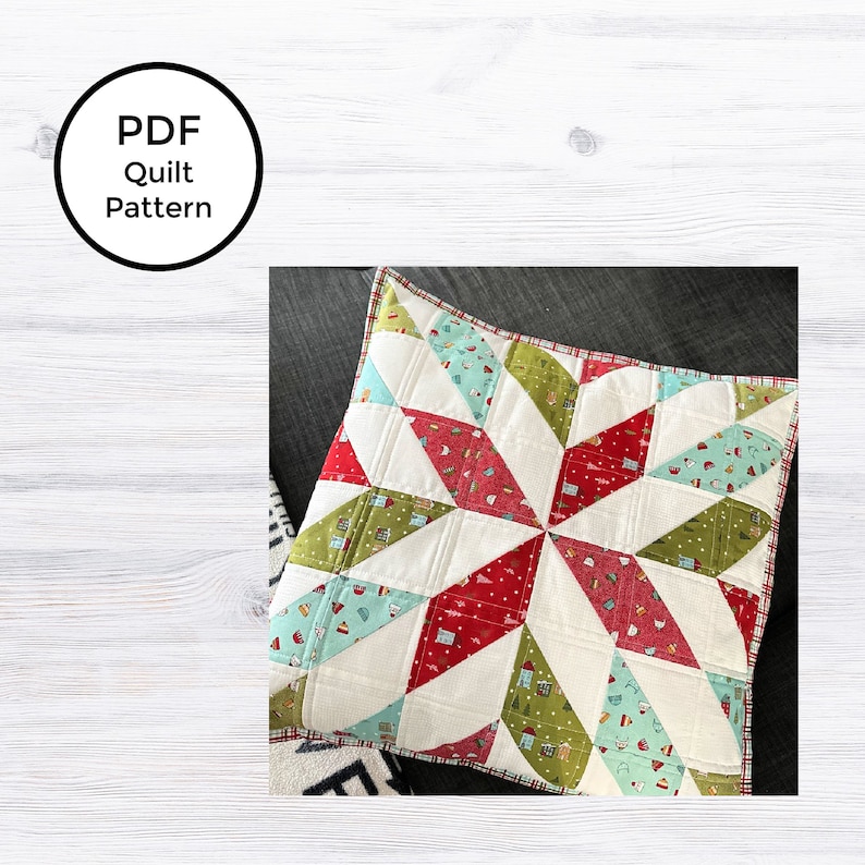 May include: A colorful quilt with a starburst design. The quilt features red, green, and blue patterned fabric sections, with white sections separating them. The quilt is bordered with a red and white plaid pattern. The image includes the text "PDF Quilt Pattern".