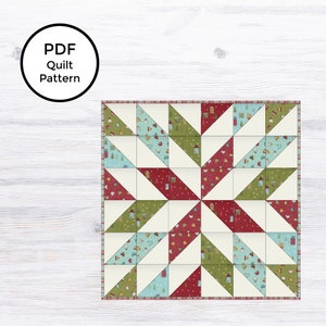 May include: A PDF quilt pattern featuring a star design. The quilt is composed of triangular blocks in red, green, and blue, with white accents. The blocks are decorated with festive patterns. The text "PDF Quilt Pattern" is in a black circle.