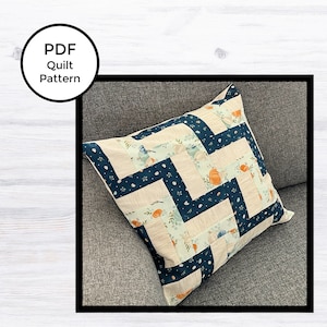 May include: A PDF quilt pattern for a pillow with a zig-zag design featuring blue, white, and green fabric with a pumpkin print.