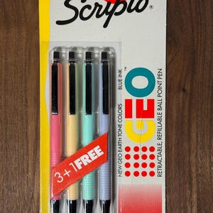 Może przedstawiać: Opakowanie długopisów kulkowych Scripto Geo w pastelowych kolorach. Długopisy są różowe, żółte, miętowe i jasnofioletowe. Opakowanie zawiera napis "3+1 GRATIS" i "Made in U.S.A."