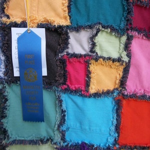 Colorful upcycled blue jeans denim quilt, faux chenille seams, fleece lined, navy/grey plaid backing; large lap/short twin size, no-shed rag