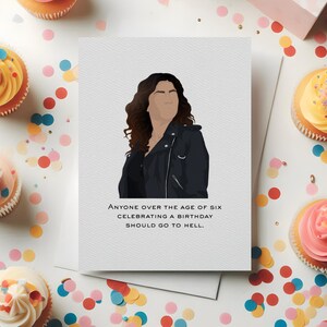 May include: Greeting card featuring a stylized illustration of a person in a black jacket. The card reads: "Anyone over the age of six celebrating a birthday should go to hell." Cupcakes and confetti are scattered around.